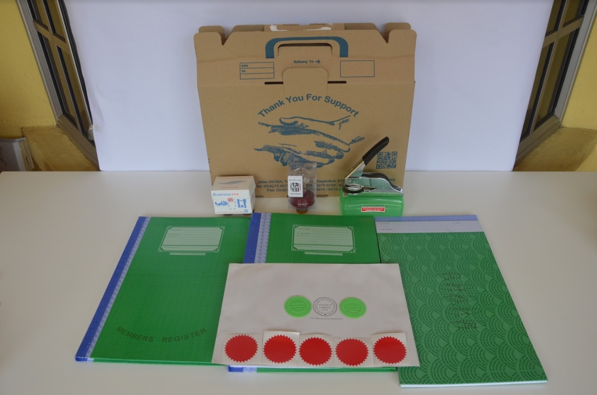 Full Package Set laid out — delivery box, statutory books, pocket seal, flash stamp, stickers, plates